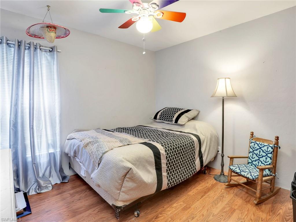 9083 Aster Road Fort Myers, FL 33967 - Photo 19 of 30 a bedroom with bed and a chandelier