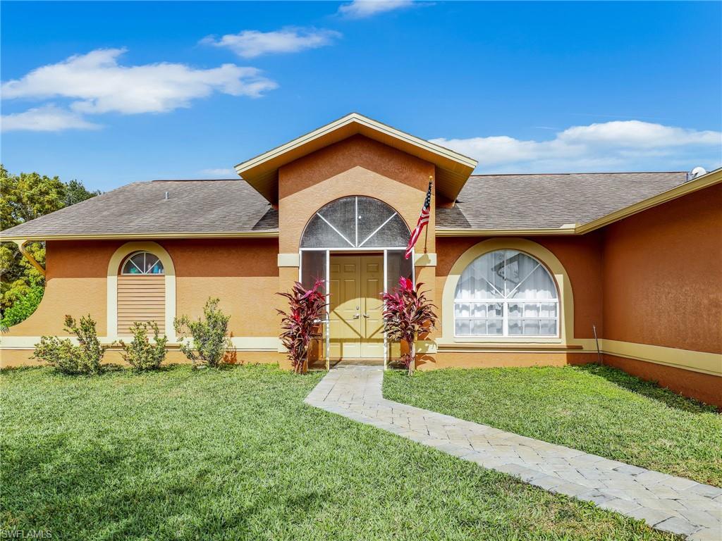 9083 Aster Road Fort Myers, FL 33967 - Photo 2 of 30 a front view of a house with a yard
