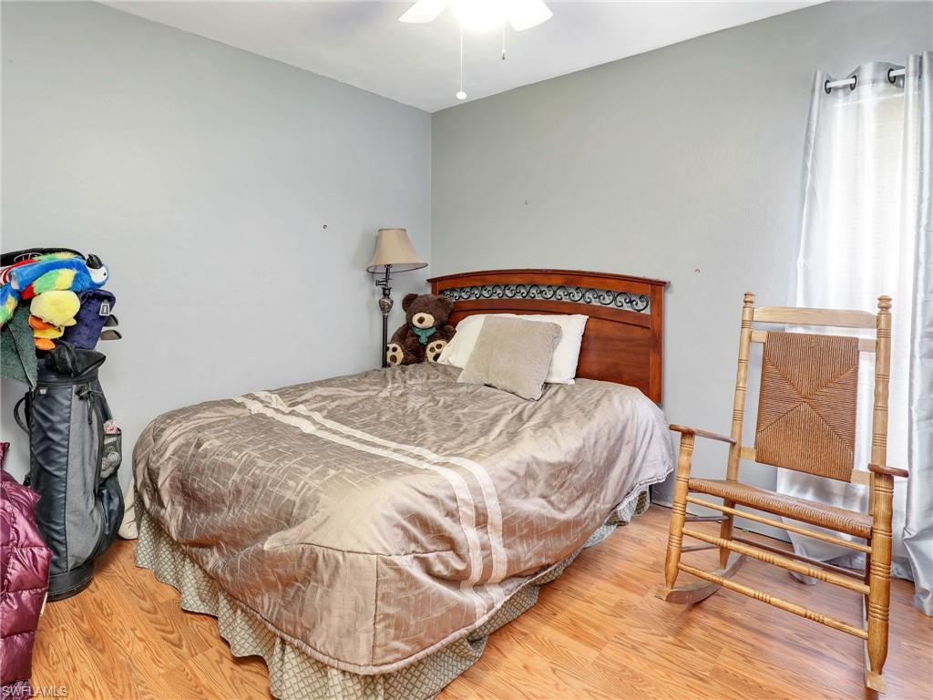 9083 Aster Road Fort Myers, FL 33967 - Photo 21 of 30 a bedroom with a bed and dresser