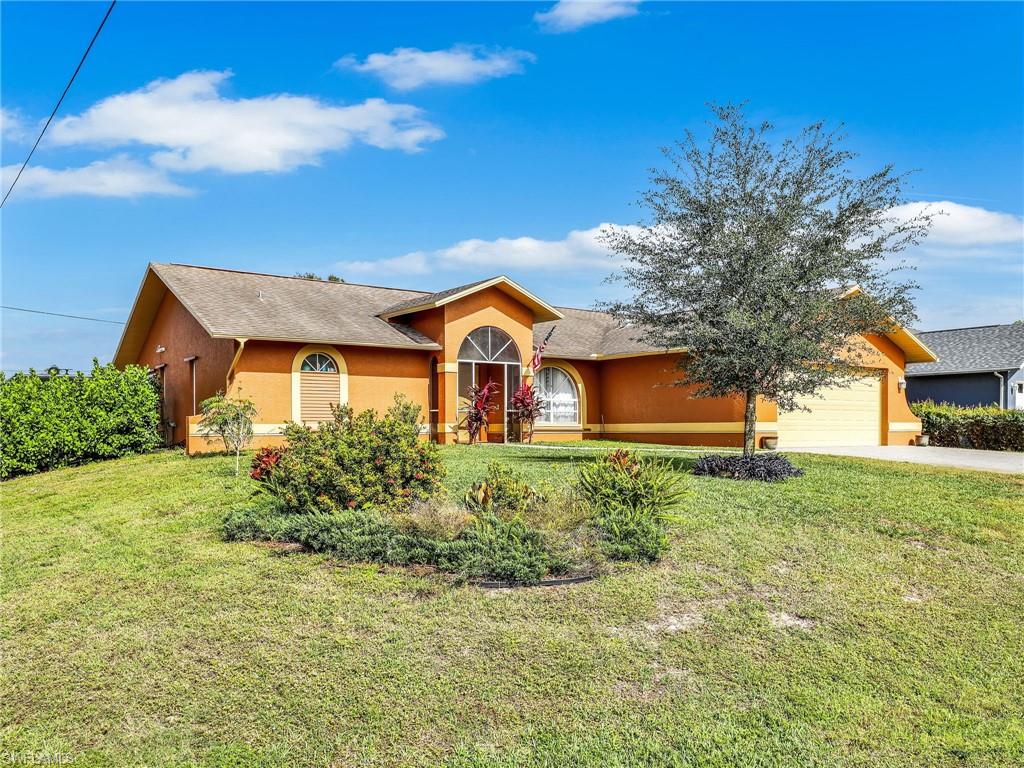 9083 Aster Road Fort Myers, FL 33967 - Photo 26 of 30 a front view of house with yard and green space