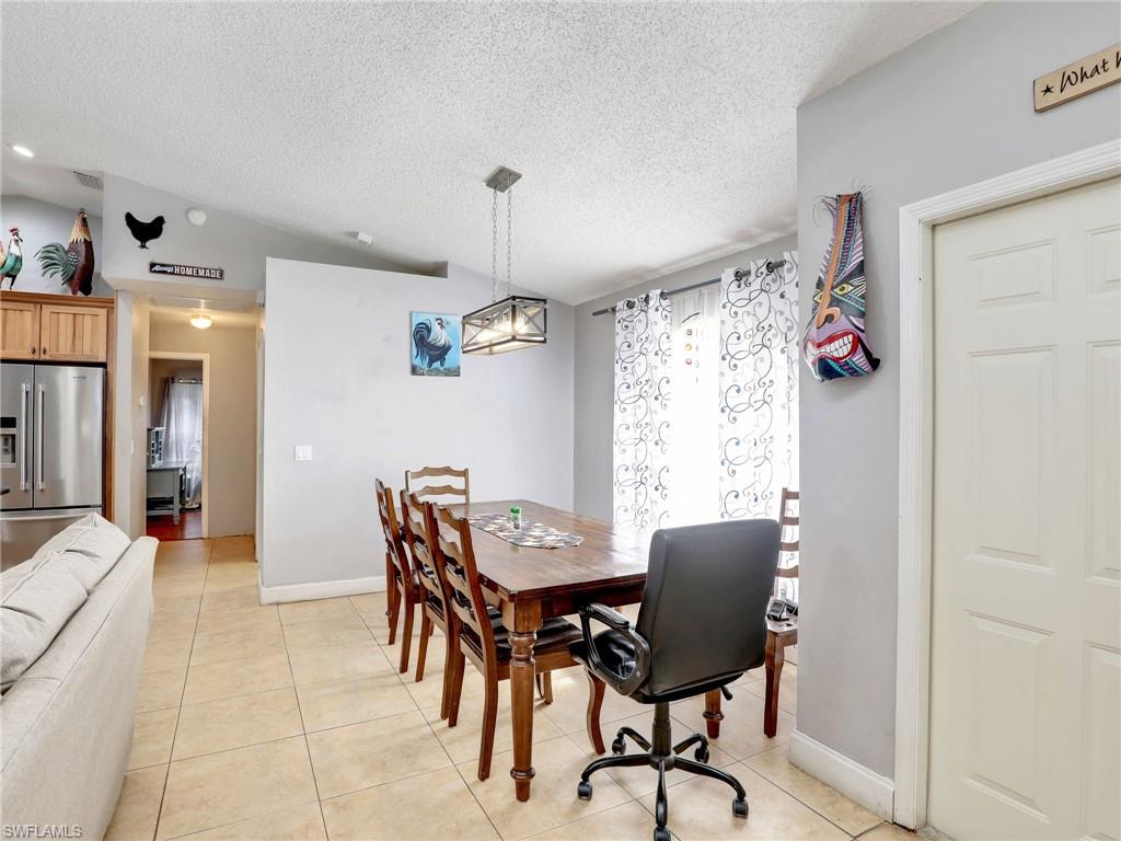 9083 Aster Road Fort Myers, FL 33967 - Photo 4 of 30 a view of a dining room with furniture and chandelier