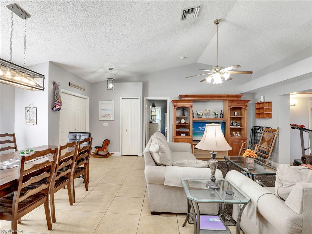 9083 Aster Road Fort Myers, FL 33967 - Photo 7 of 30 a dining room with furniture a chandelier and window