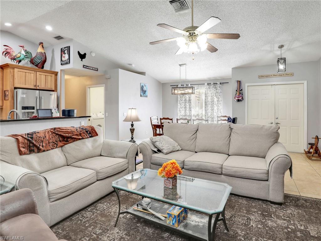 9083 Aster Road Fort Myers, FL 33967 - Photo 8 of 30 a living room with furniture a bed and a chandelier