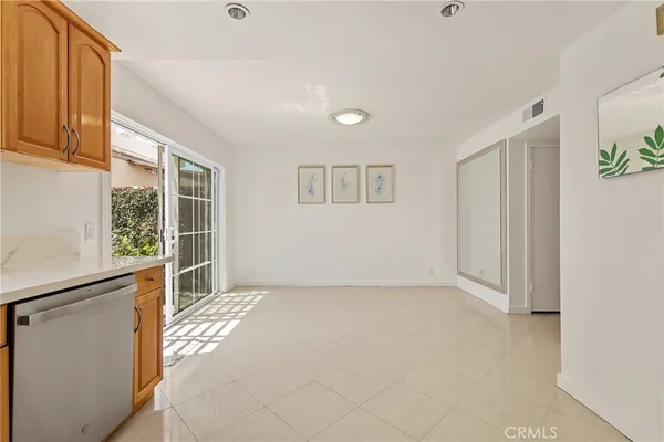 a view of kitchen with stainless steel appliances granite countertop a stove and a sink