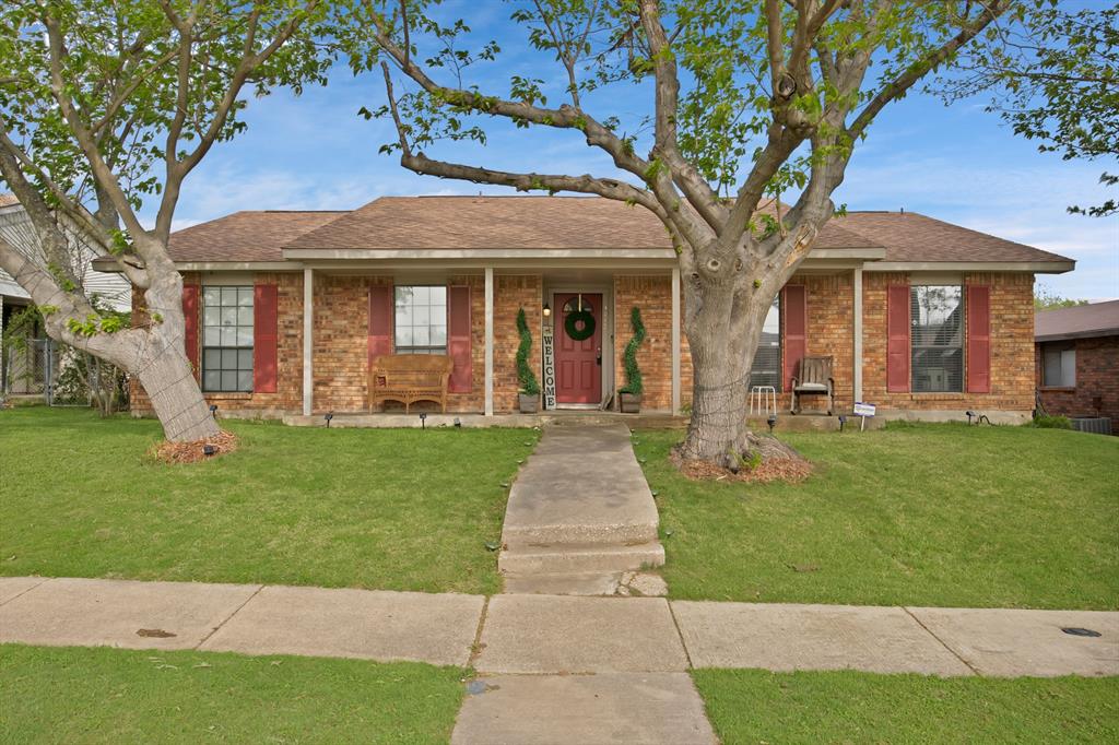 9712 White Ash Road Dallas, TX 75249 - Photo 1 of 1 Ranch-style home with a front yard, a porch, brick siding, and roof with shingles