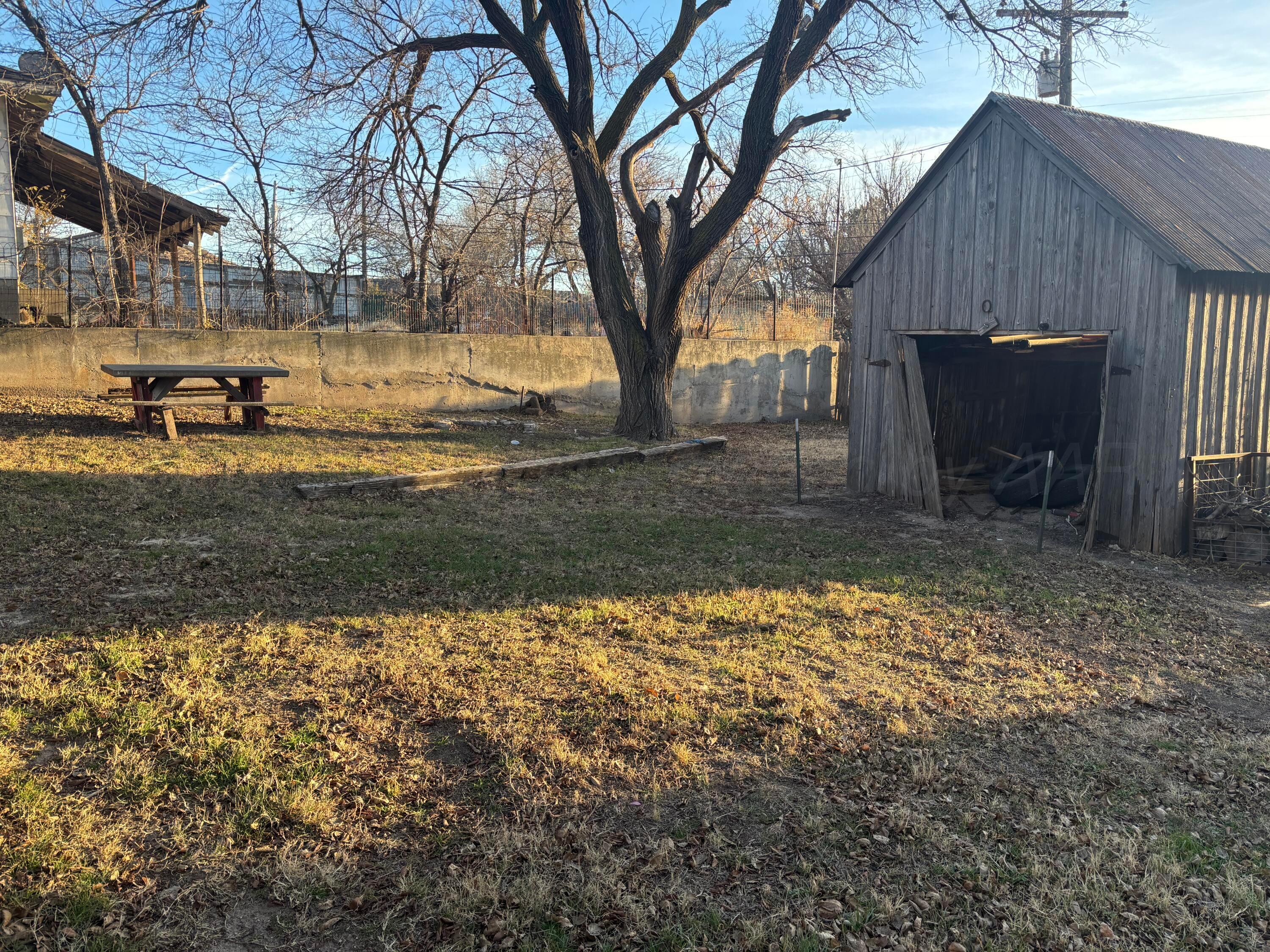 206 Harvey Street Miami, TX 79059 - Photo 6 of 7 a view of a backyard with large trees