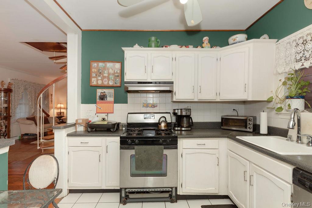104 Fordham Street, Unit 5 Bronx, NY 10464 - Photo 15 of 27 a kitchen with granite countertop a sink stainless steel appliances and cabinets