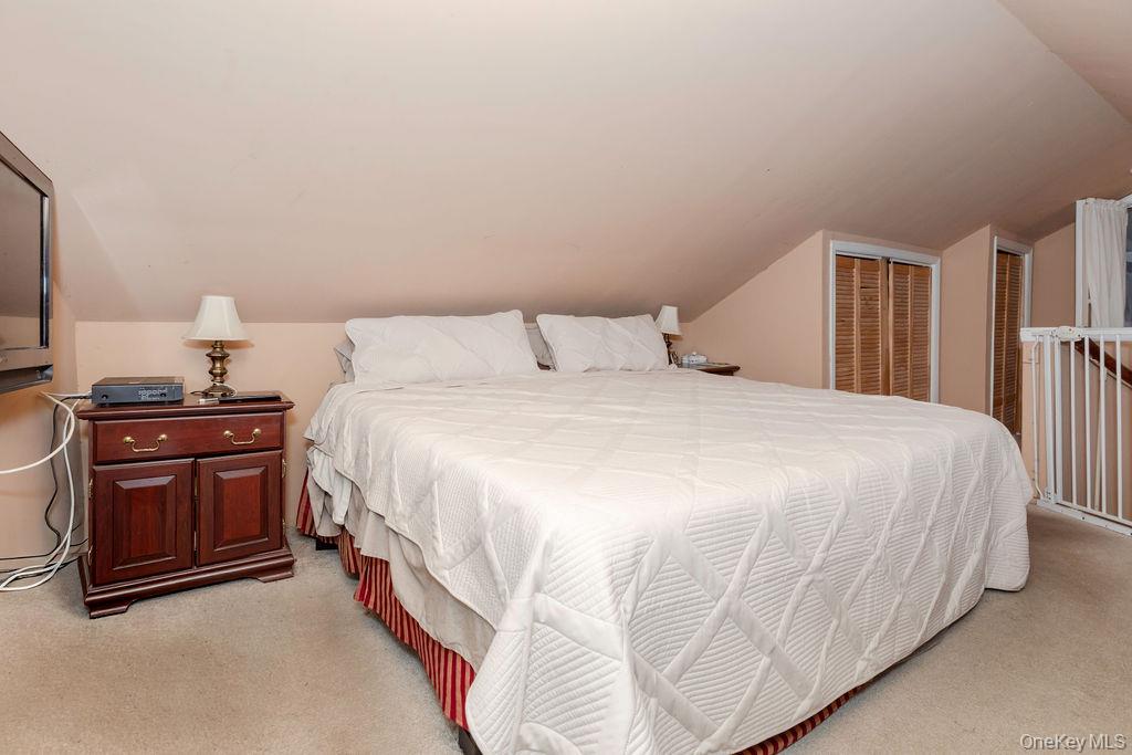 104 Fordham Street, Unit 5 Bronx, NY 10464 - Photo 17 of 27 a spacious bedroom with a bed and a lamp