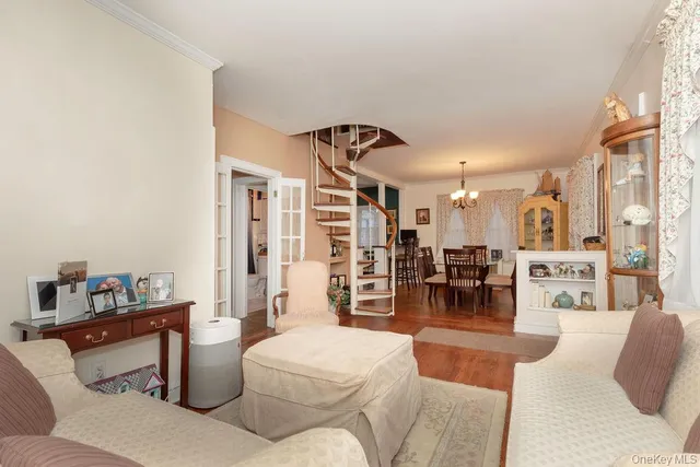 a living room with furniture and a dining table with kitchen view