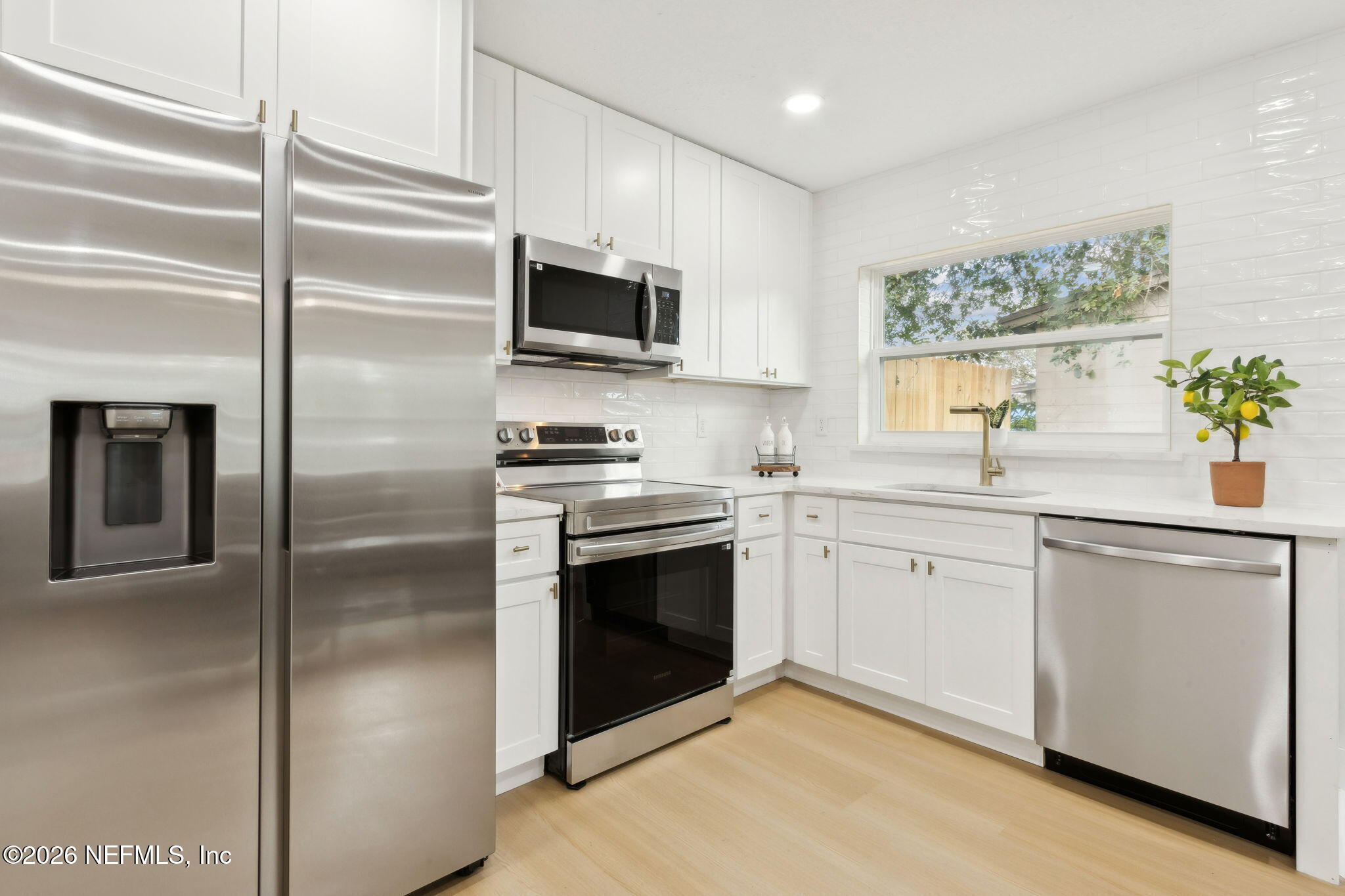 14051 Claridge Road North Jacksonville, FL 32250 - Photo 16 of 43 a kitchen with a sink stainless steel appliances and white cabinets