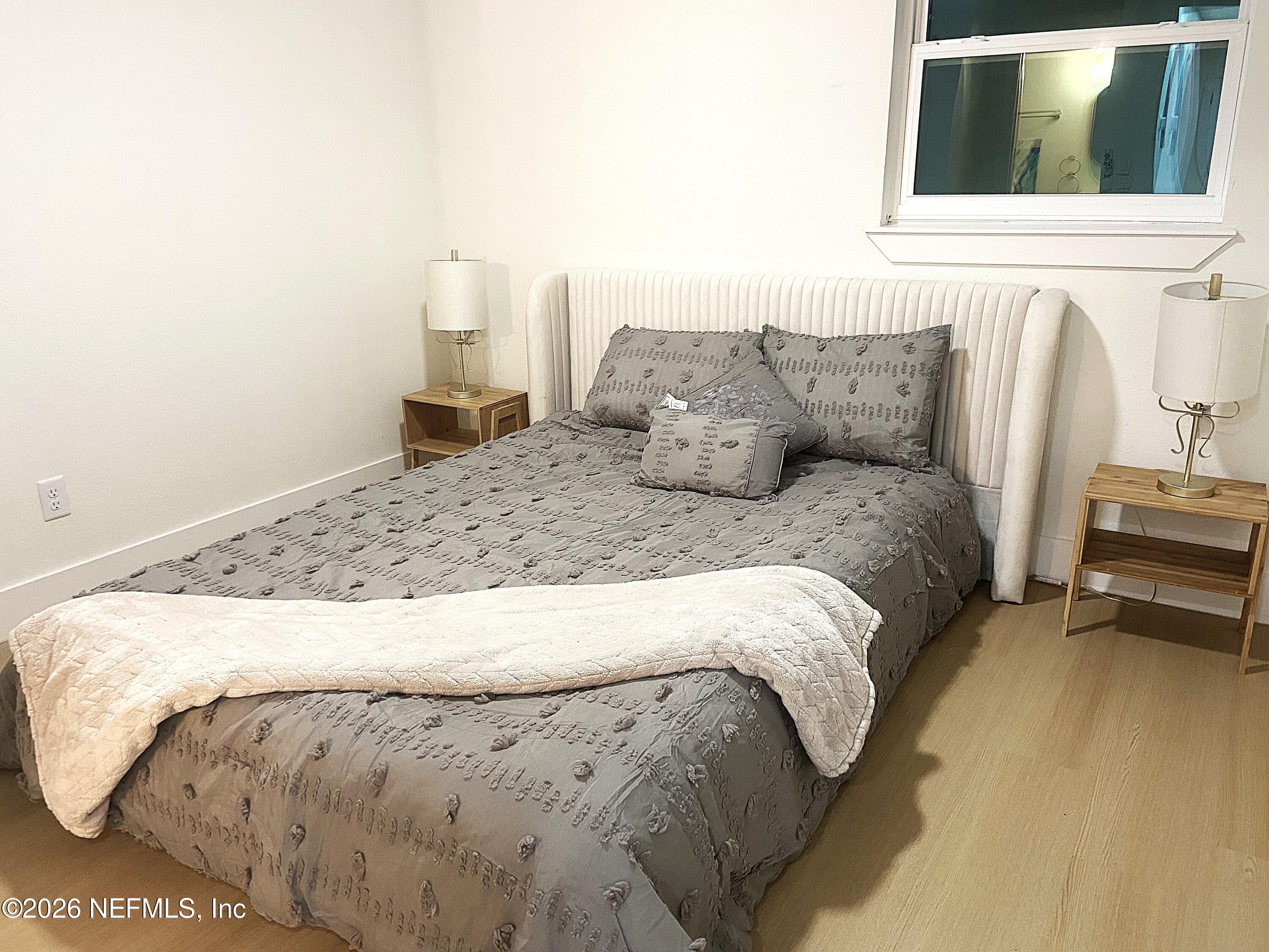 14051 Claridge Road North Jacksonville, FL 32250 - Photo 18 of 43 a bed sitting in a bedroom next to a window