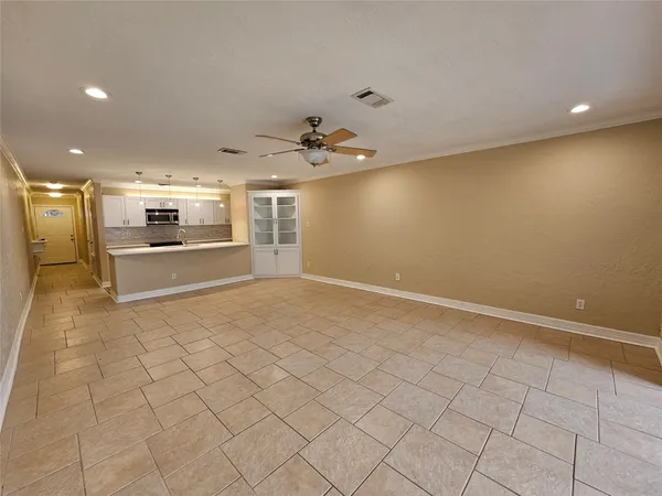 wooden floor in an empty room with a kitchen