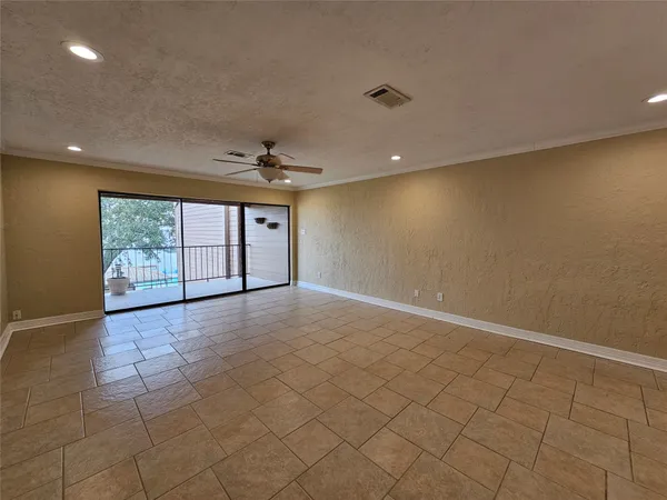 a large kitchen with a large counter top a sink and stainless steel appliances