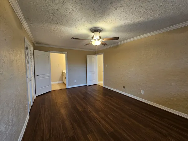 a bathroom with a granite countertop toilet a sink and shower