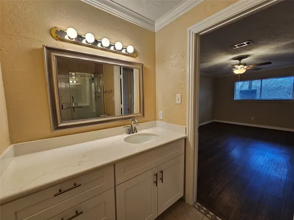 a bathroom with a double vanity sink mirror and toilet