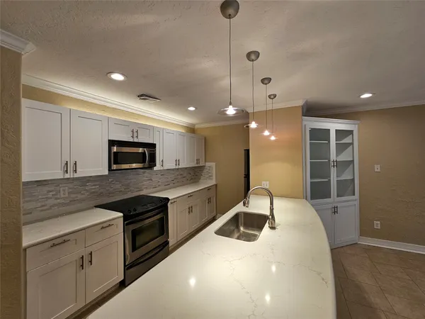 a kitchen with stainless steel appliances granite countertop a stove and a sink