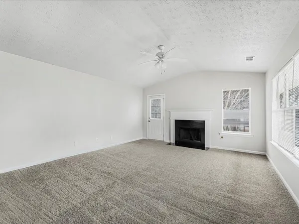 a view of empty room with a fireplace
