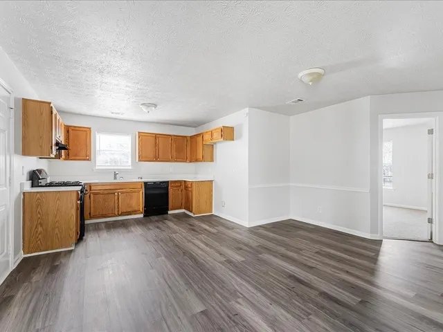 a view of kitchen with microwave and cabinets