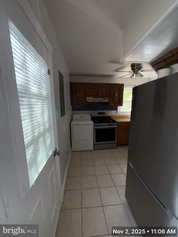 a kitchen with a refrigerator and a stove