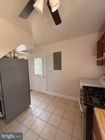 a kitchen with a stove sink and cabinets