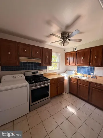 a kitchen with a stove top oven and cabinets