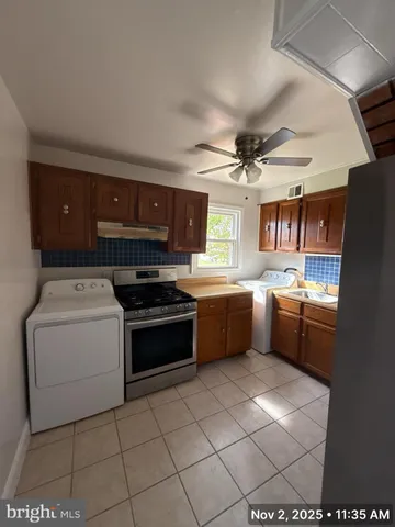 a kitchen with a stove a sink and a refrigerator