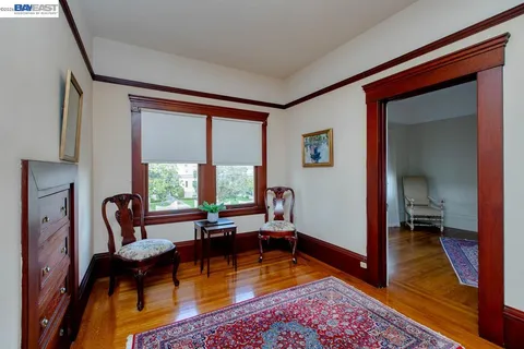 a spacious bedroom with a bed and wooden floor
