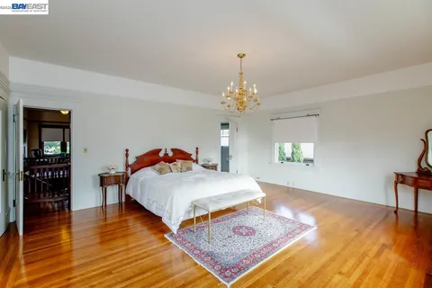 a large room with wooden floor and a rug