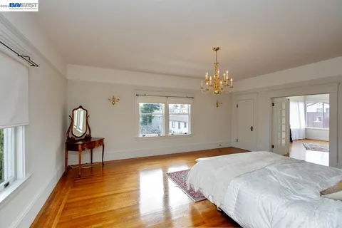 a bedroom with bed and a chandelier