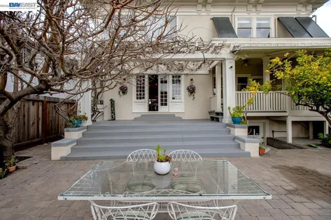 a front view of a house with a yard table and chairs