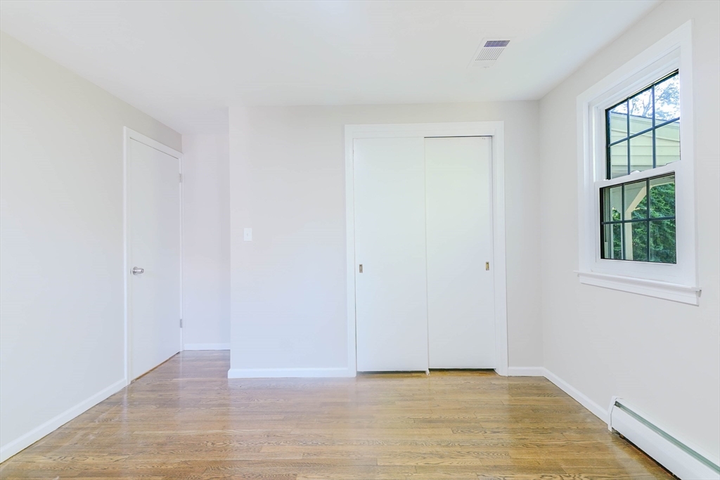 102 McCarthy Avenue Chicopee, MA 01020 - Photo 12 of 18 a view of an empty room with wooden floor and a window