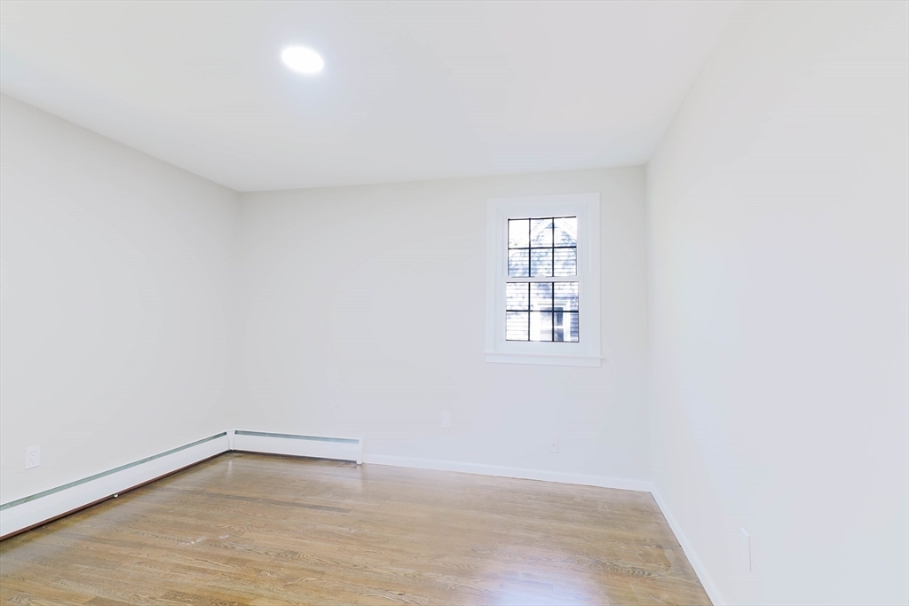 102 McCarthy Avenue Chicopee, MA 01020 - Photo 13 of 18 an empty room with wooden floor and windows