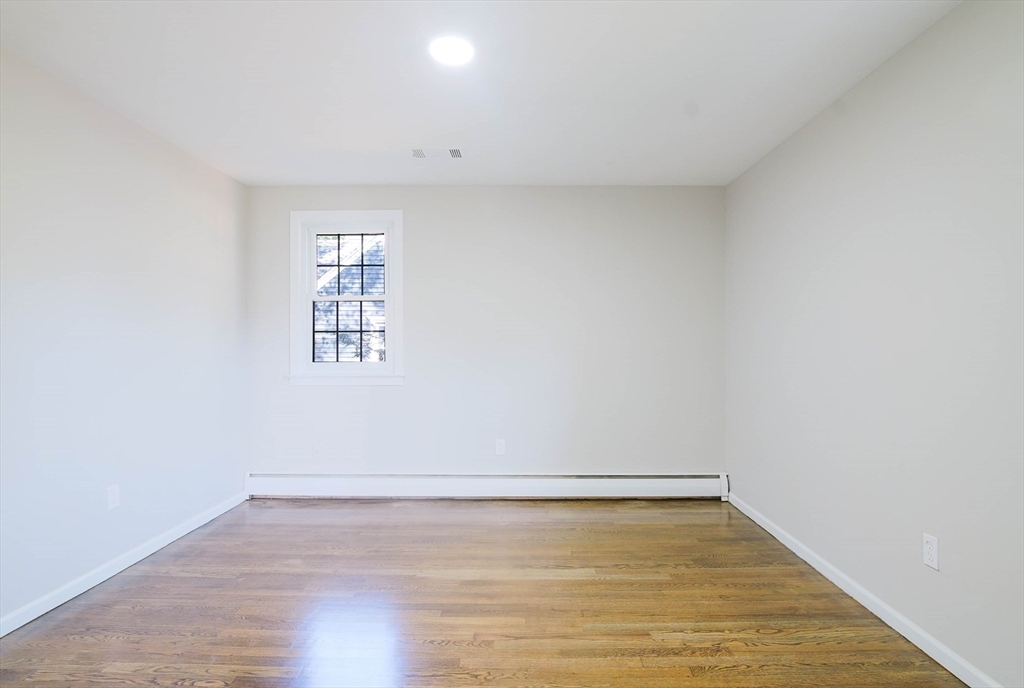 102 McCarthy Avenue Chicopee, MA 01020 - Photo 14 of 18 a view of an empty room with wooden floor and a window