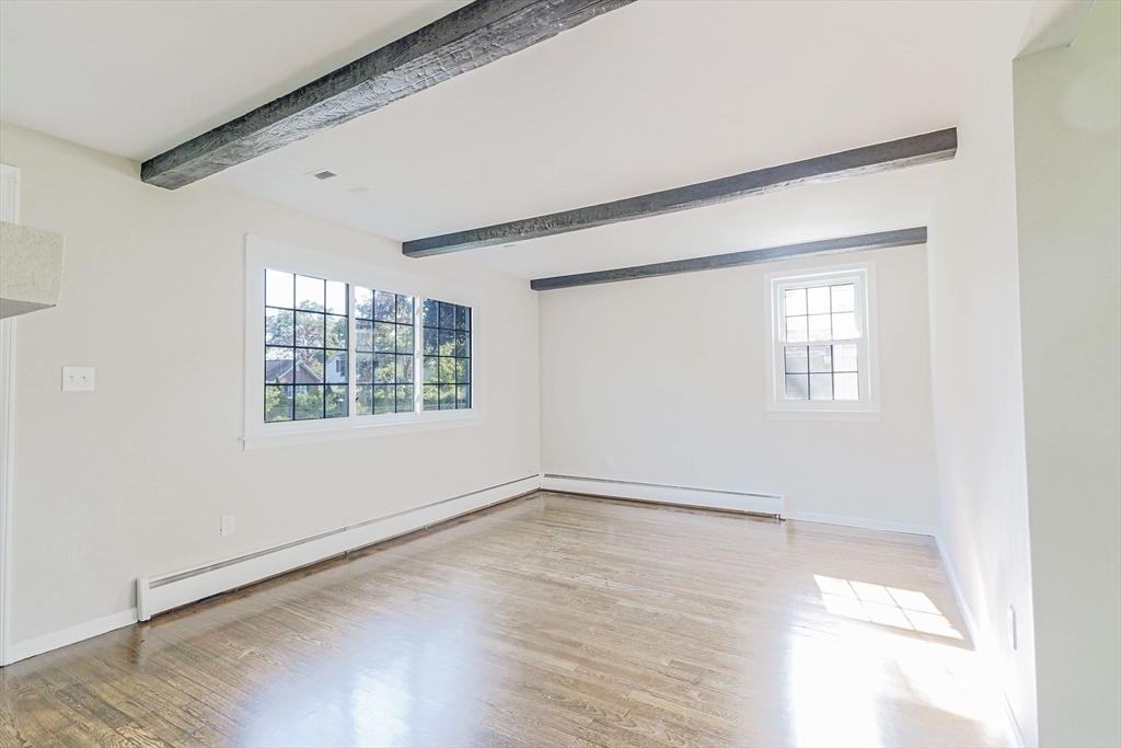 102 McCarthy Avenue Chicopee, MA 01020 - Photo 2 of 18 an empty room with wooden floor and windows