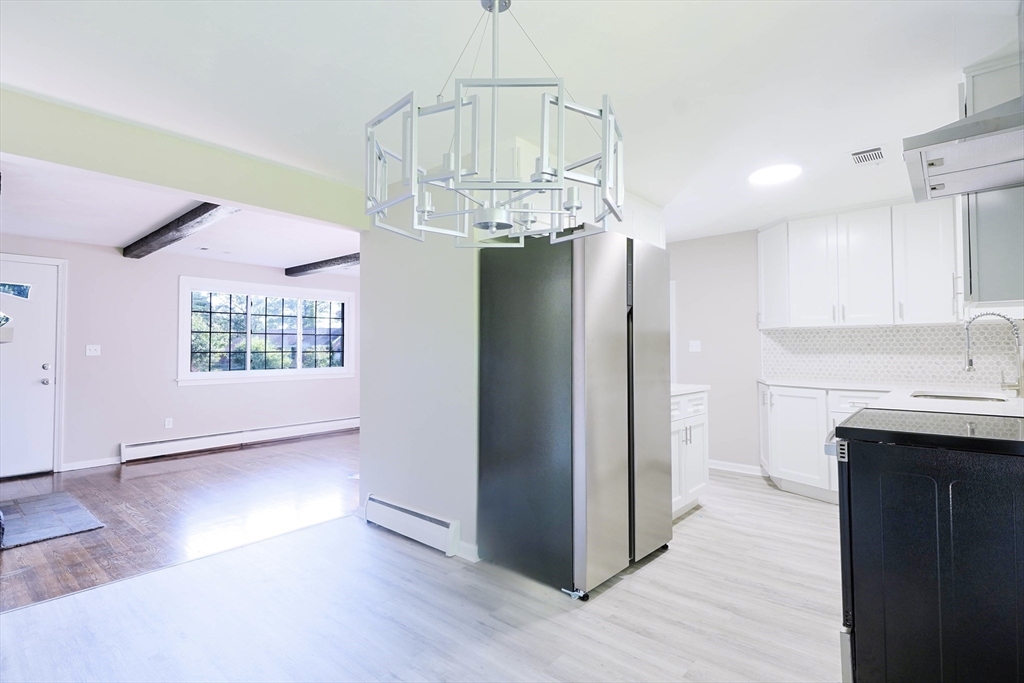 102 McCarthy Avenue Chicopee, MA 01020 - Photo 3 of 18 a view of a kitchen with a sink and dishwasher a refrigerator with wooden floor