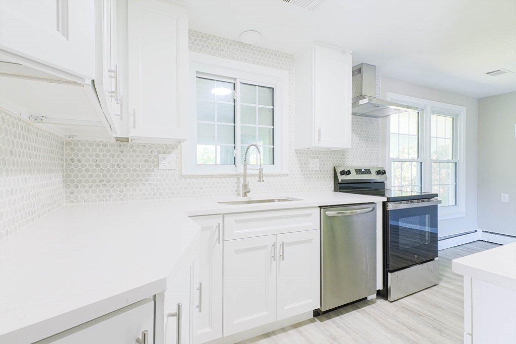 102 McCarthy Avenue Chicopee, MA 01020 - Photo 6 of 18 a kitchen with cabinets appliances a sink and a window