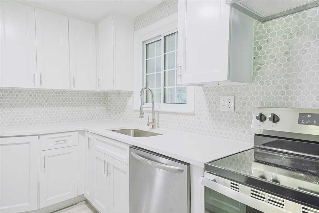 102 McCarthy Avenue Chicopee, MA 01020 - Photo 7 of 18 a kitchen with a sink and cabinets
