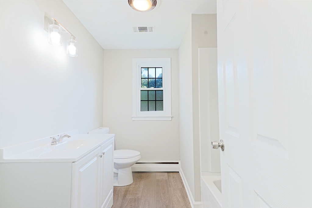 102 McCarthy Avenue Chicopee, MA 01020 - Photo 8 of 18 a bathroom with a sink a toilet and shower