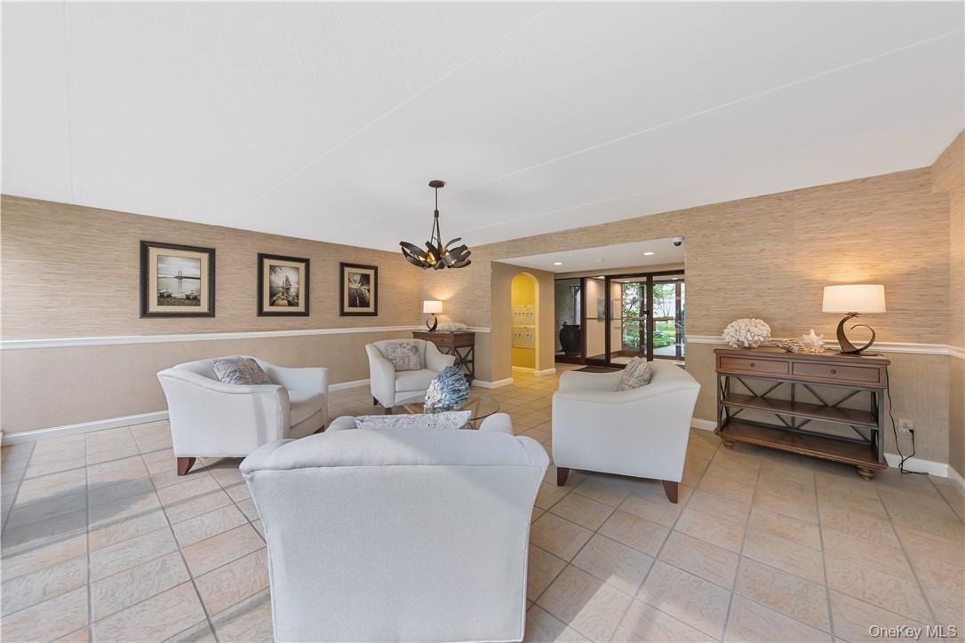 150 Overlook Avenue, Unit 2K Peekskill, NY 10566 - Photo 20 of 26 a living room with furniture and a chandelier