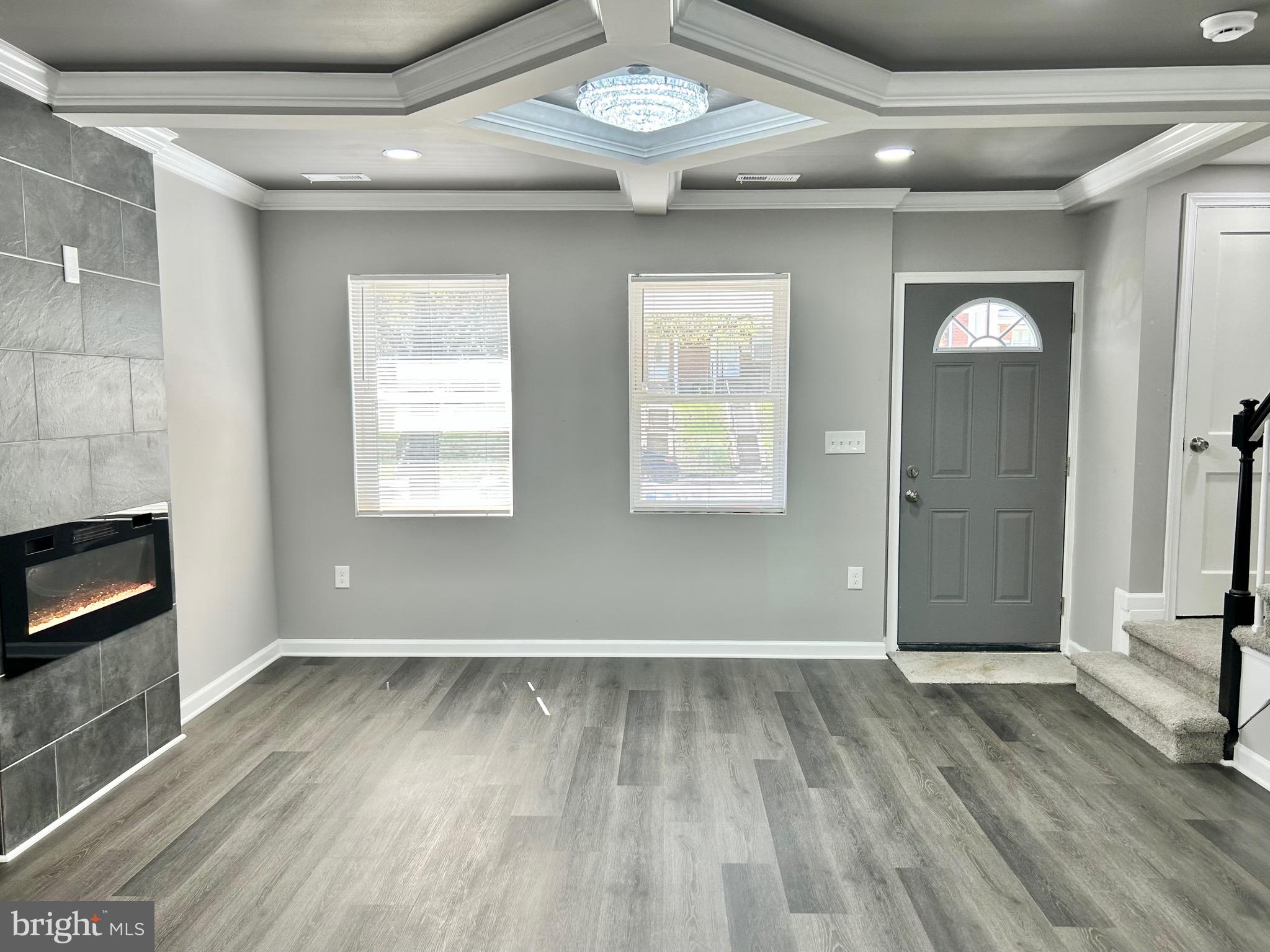 1652 Ramblewood Road Baltimore, MD 21239 - Photo 4 of 25 a view of an empty room with wooden floor and a window