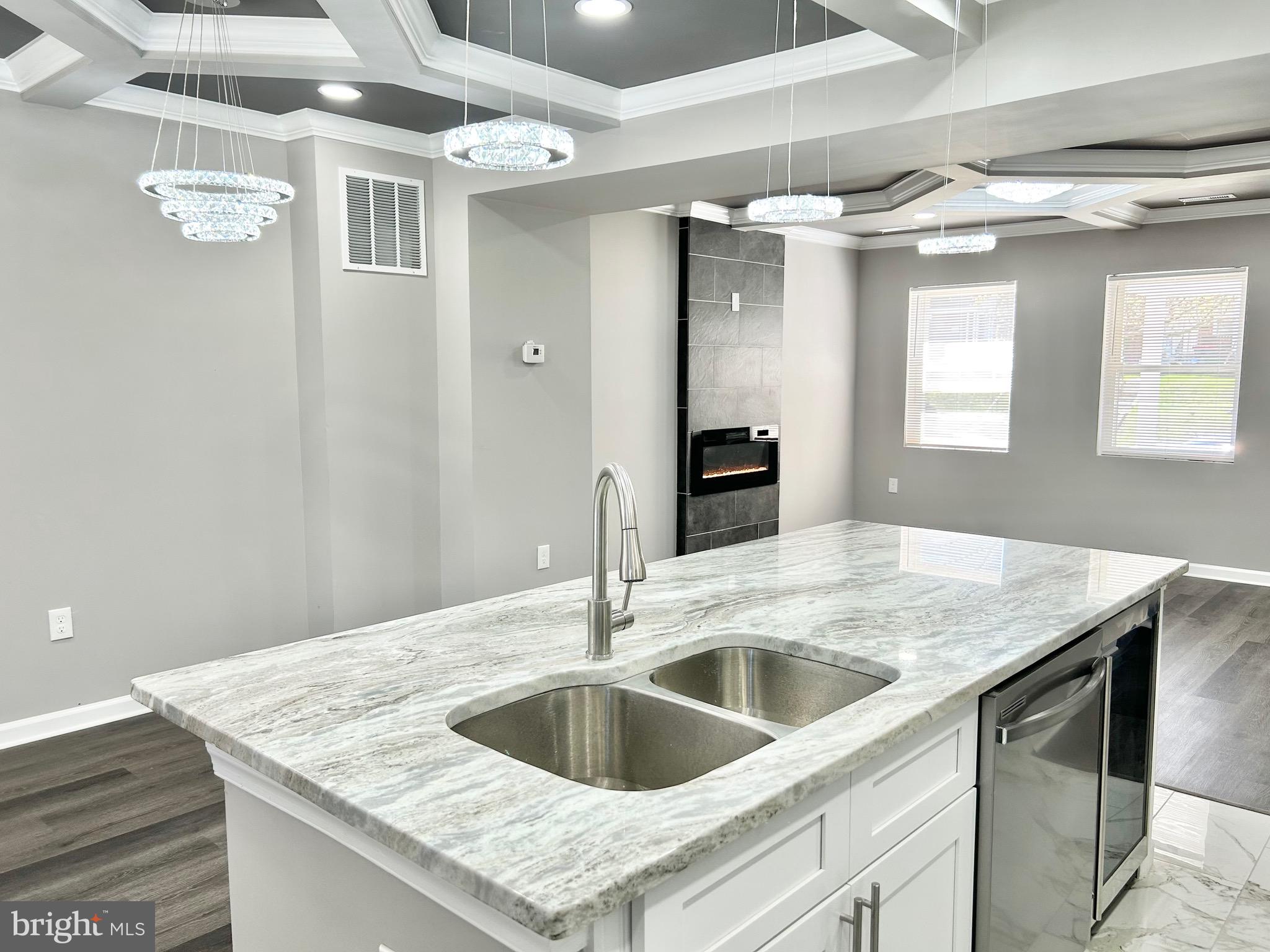 1652 Ramblewood Road Baltimore, MD 21239 - Photo 8 of 25 a kitchen with a sink dishwasher and a refrigerator