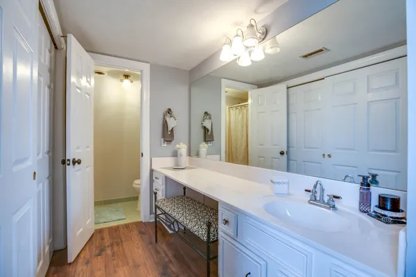 a en suite bathroom with a double vanity sink and a mirror
