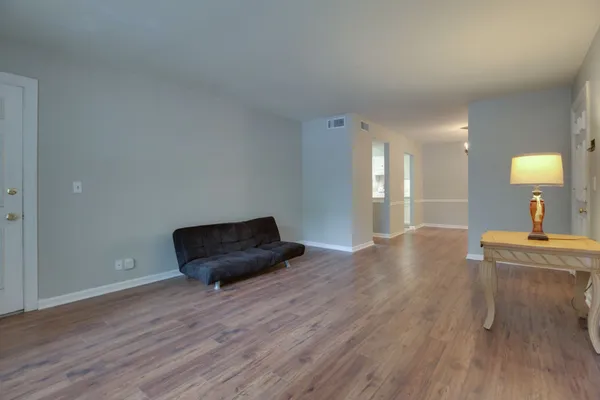 a living room with a couch and a wooden floor