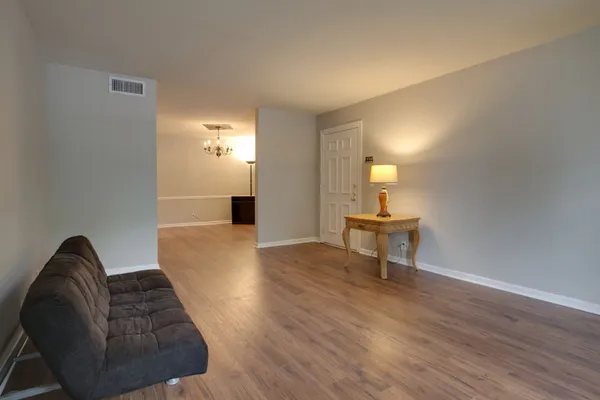 a living room with furniture and a wooden floor