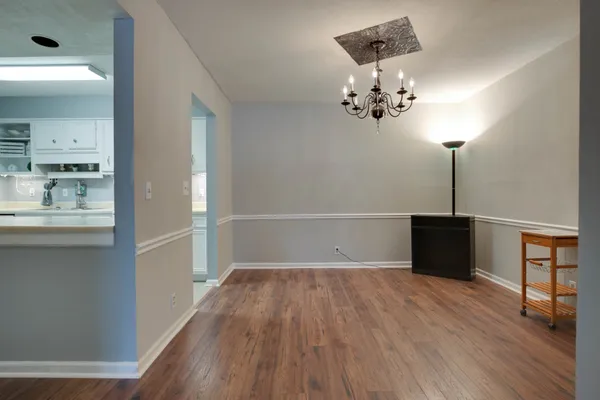 a view of a room with wooden floor and window