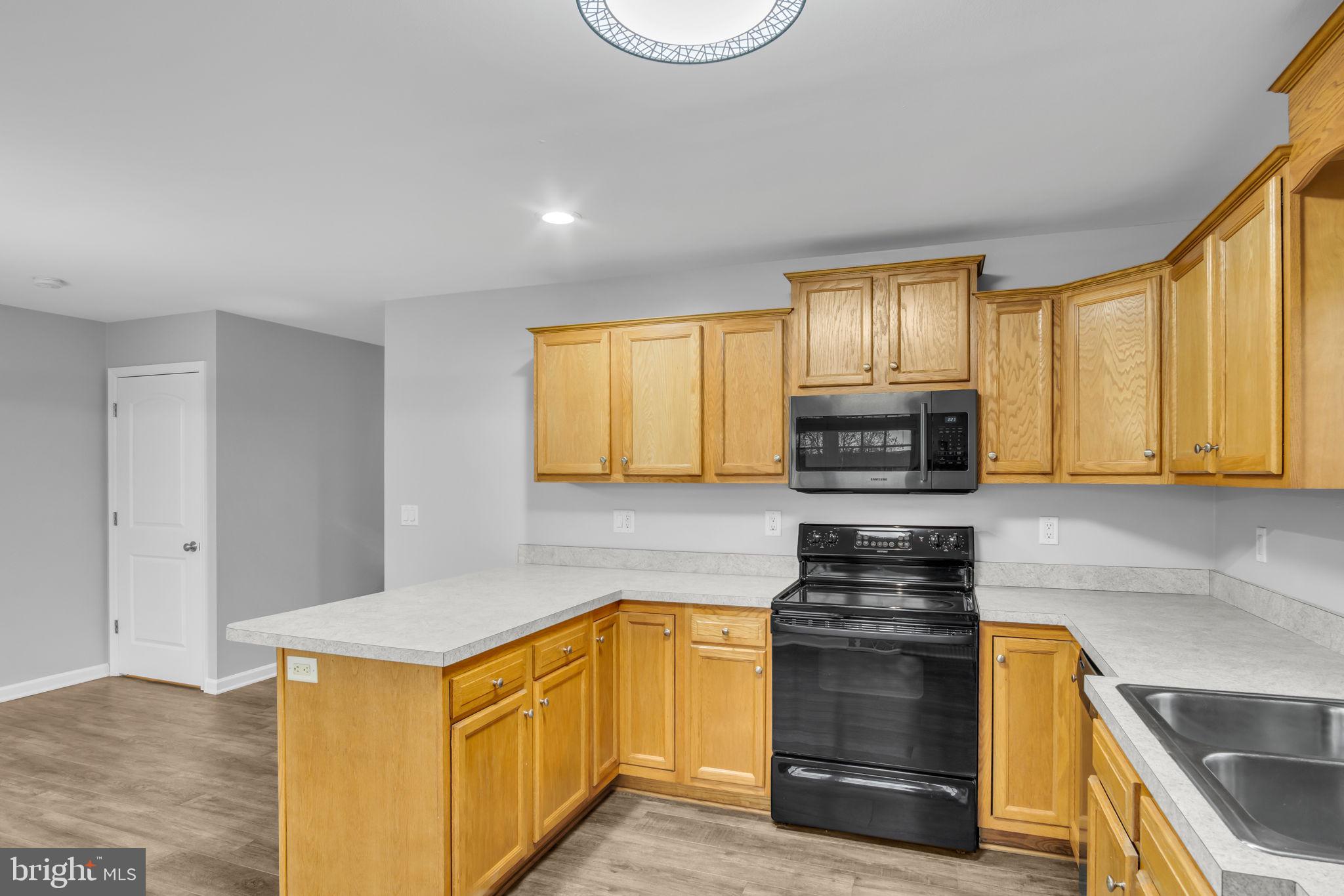 2 Sue Circle Lebanon, PA 17042 - Photo 11 of 32 a kitchen with stainless steel appliances granite countertop a stove a sink and a microwave