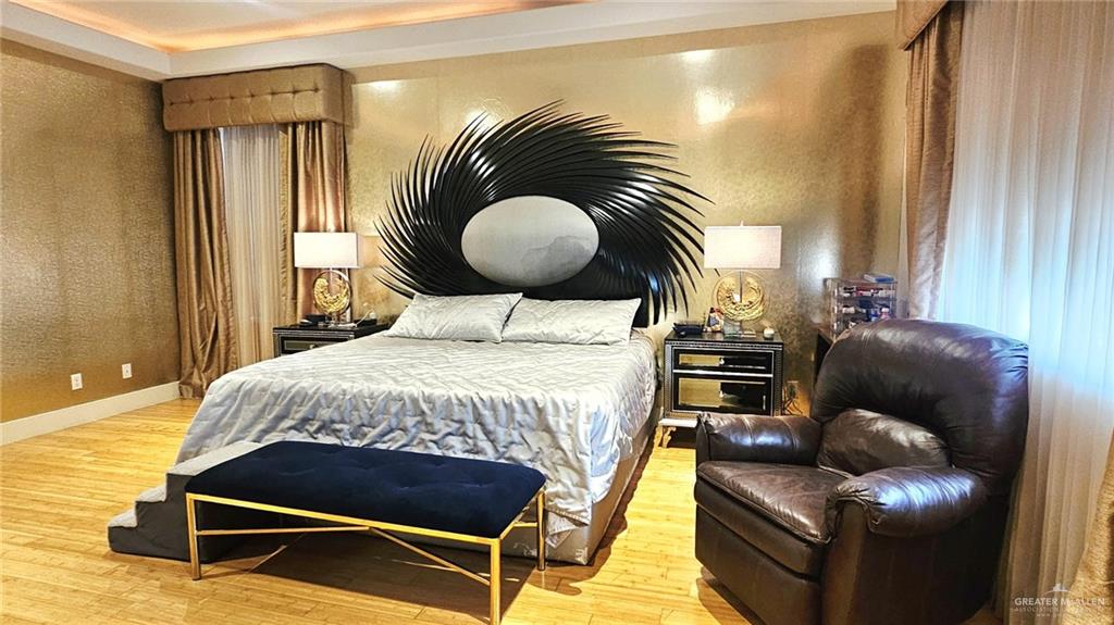 2213 South 48th Street McAllen, TX 78503 - Photo 13 of 28 a bedroom with a bed and wooden floor