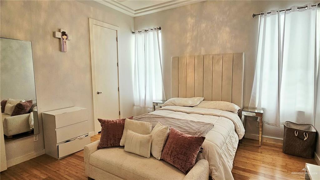 2213 South 48th Street McAllen, TX 78503 - Photo 19 of 28 a bedroom with a bed and wooden floor