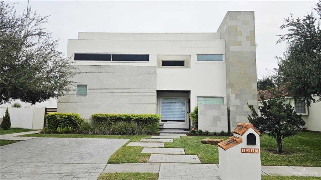 2213 South 48th Street McAllen, TX 78503 - Photo 2 of 28 a front view of a house with garden