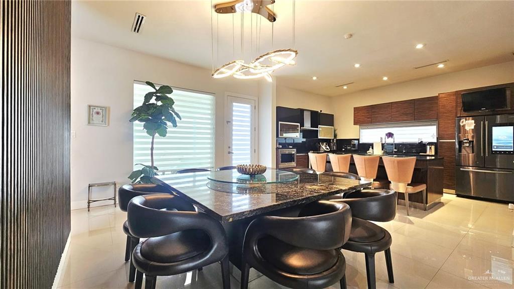 2213 South 48th Street McAllen, TX 78503 - Photo 7 of 28 a kitchen with a dining table chairs stove and living room view